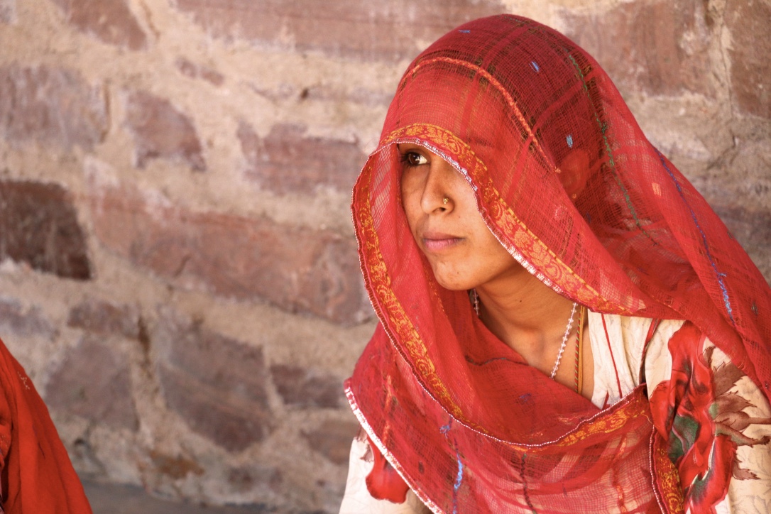Rajasthani woman exhibiting Rajasthani Custom and tradition by wearing a ghagra- choli & a veiled cotton odhni